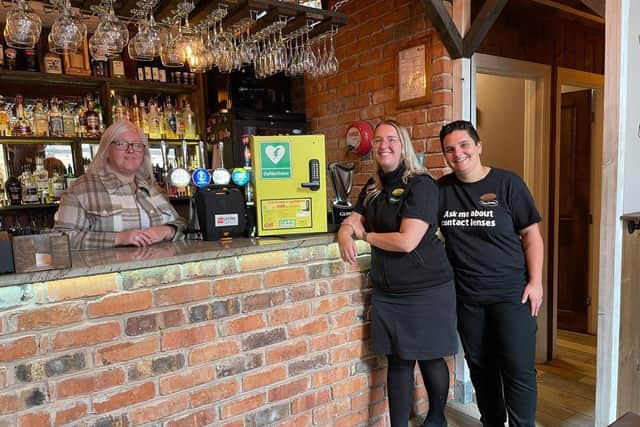 Staff at The Cowshed with the defibrillator donated by Specsavers