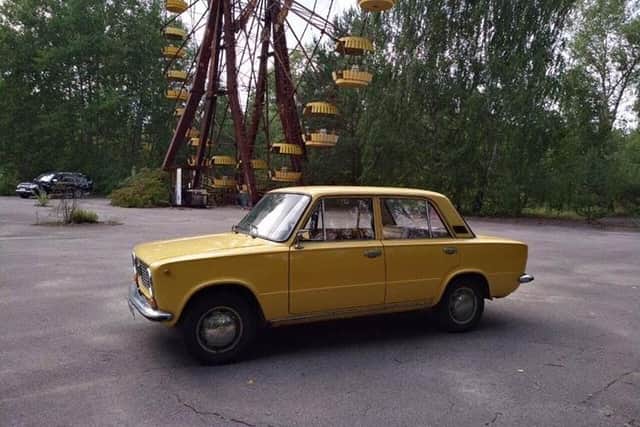 The yellow Lada is used to take tourists around the Chernobyl site at Pripyat