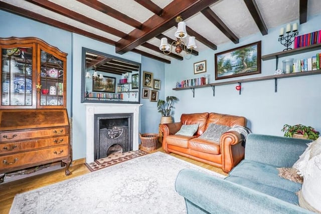 The second reception room is this warm and cosy sitting room. The character of the property really shines here, thanks to a feature fireplace and ceiling beams.