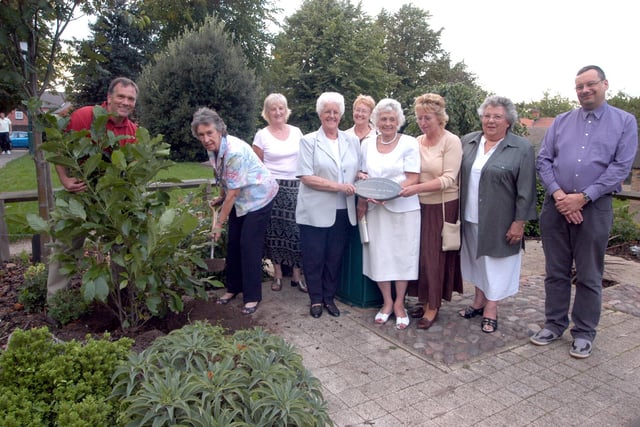 John Stirland. left, gives Judith Bragg, second left, President of Hucknnall Inner Wheel, a hand to plant a tree for International Peace Day at the Byron Memorial Garden in 2006.