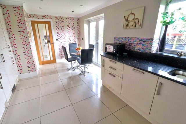 French doors that lead to the garden, tiled flooring, underfloor heating, a sink and drainer with granite worktops and matching granite splashbacks are all other assets of the dining kitchen.