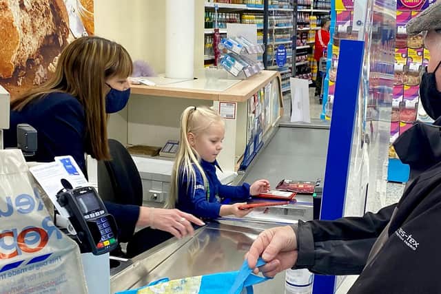Brooke 'worked' on the tills, scanning in items and chatting with customers. Photo: Jodie Buckley/SWNS