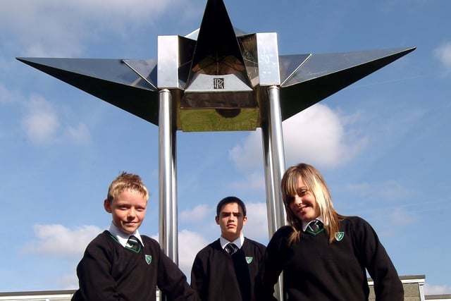 Pupils Joe Crespo, 14, Ryan King, 13, and Kemrie Johnson, 13, model the new uniform at Holgate Comprehensive School in front of the school's sculptures.
