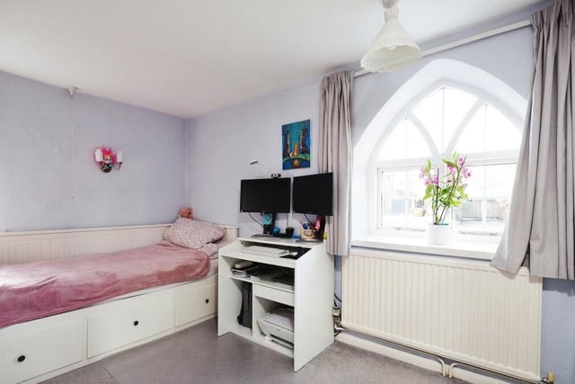 The £375,000 Hucknall property is distinguished by several quirky arched windows. Here is one of them in the second bedroom on the first floor.