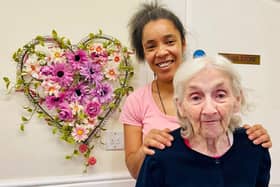 Natasha Lindo, Hall Park activities co-ordinator, left, with a resident and her creation.