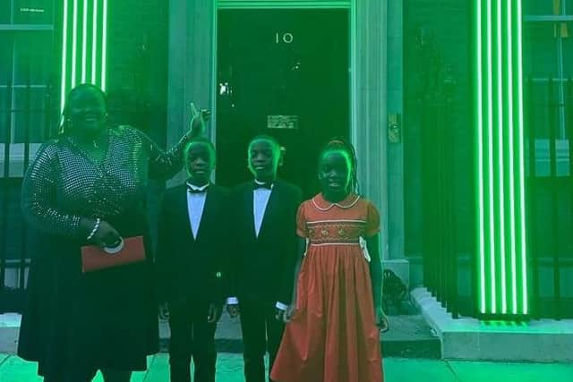 Triplets Waimi, Mbetmi and Yimi Fongue, with mum Esther, outside 10 Downing Street