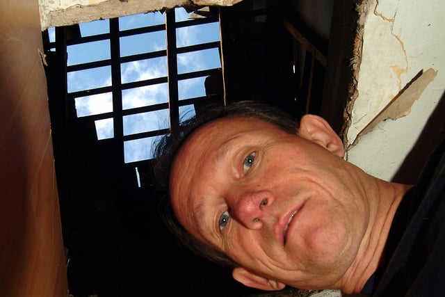 2007: Kevin Pearson is shown with the hole in his roof, caused by storm damage in Hucknall.