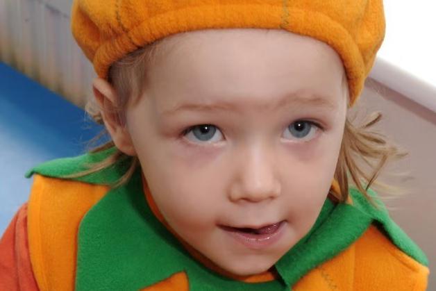 Dressed as a festive little pumpkin, a young partygoer celebrates the spooky season at Hucknall Day Nursery in 2006
