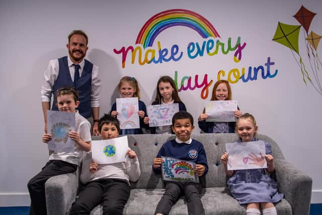 Head teacher Karl Clowery with children and their designs concerning courage and friendship inspired by Stephen Lawrence Day. Photo: Lou Brimble