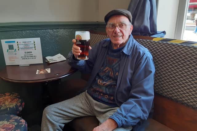 Ken Willett raises a glass to being back in his usual seat in the Red Lion