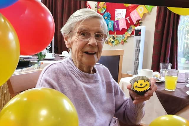 Resident Brenda Walton with one of the party cakes as Fairway View celebrated Brew Monday and Winnie the Pooh Day
