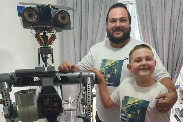 Ryan Howard and his son with their full replica of Johnny 5