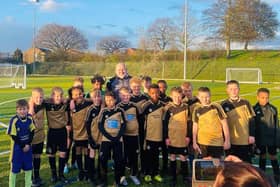Former Manchester United player Mike Phelan with the DLFC under-12s team.