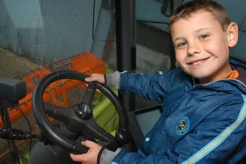 2009: Jack Rontree takes the wheel of a combined harvester during a visit to the Hall Farm open day in Watnall.
