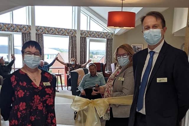 Staff and residents cut the ribbon to officially open the new dementia suite