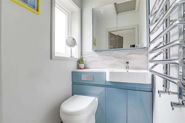 As well as the two en suite rooms, the Newstead Abbey Park bungalow features this separate toilet, where a concealed, dual-flush WC is combined with a wash basin. There is also a chrome, heated towel-rail and recessed spotlights.