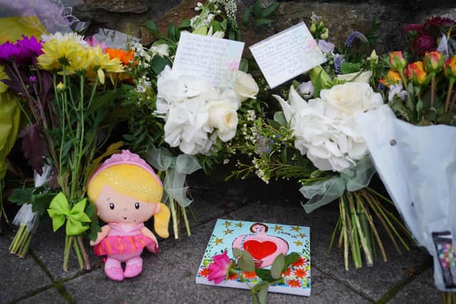 People leave flowers in the Keyham area of Plymouth where six people, including the offender, died of gunshot wounds in a firearms incident on Thursday evening. Picture date: Saturday August 14, 2021.