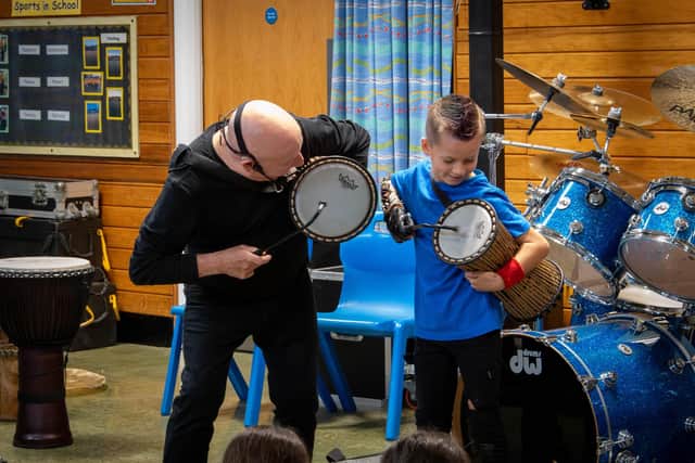 Jeff playing drums with nine-year-old Freddie Stevenson during the masterclass event. Photo: Lou Brimble