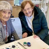 103 years old Win and her daughter Hillier enjoying a game of bingo