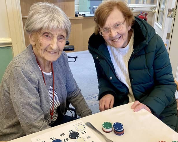 103 years old Win and her daughter Hillier enjoying a game of bingo