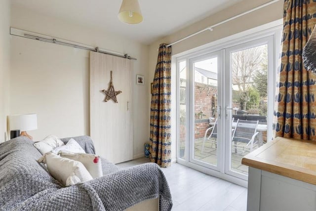 Separate to the living room is this cosy family room, which has uPVC double-glazed French doors providing access to the back garden.The floor is laminated.