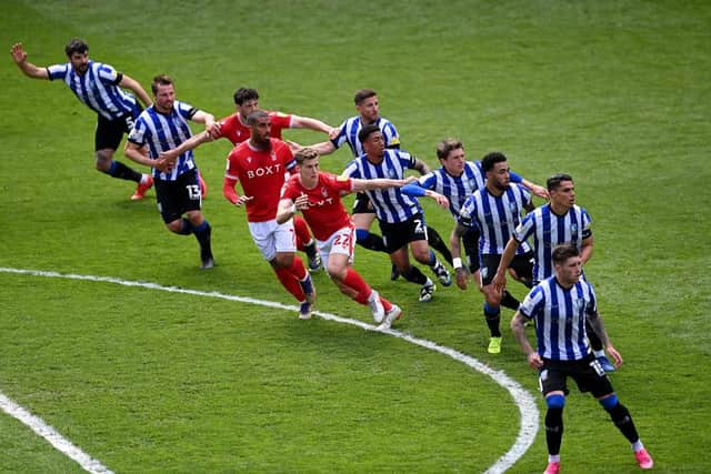 Nottingham Forest and Sheffield Wednesday players battle for possession as they wait for a corner kick to be taken.