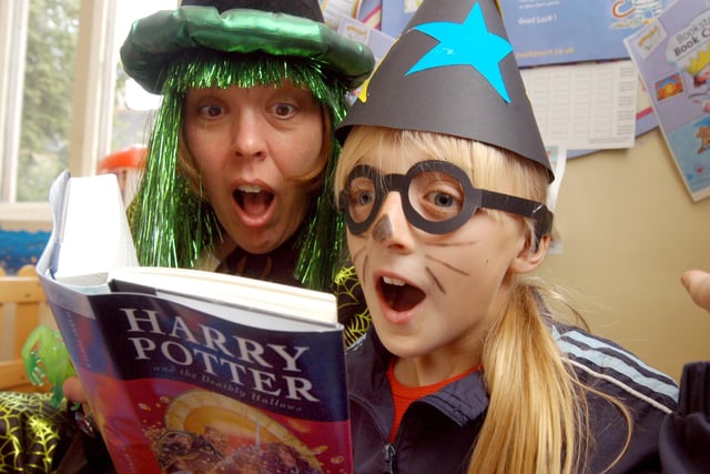 Liz Duncanson reads Harry Potter to Chloe Booth, nine, at Hucknall Library as part of their summer reading events.