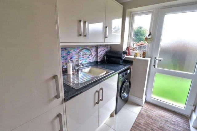 Next door to the dining kitchen is a useful utility room, which has space and plumbing for a washing machine. It boasts base and wall units for storage, plus a sink, drainer and granite worktop. Doors lead to the garden and the garage.