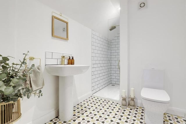 The master bedroom is served by this stylish shower room suite. It consists of a shower enclosure with overhead 'rainfall' shower head and a shower screen, wash basin with a mono mixer tap, low-level, dual-flush WC, heated towel-rail, tiled flooring and recessed spotlights.