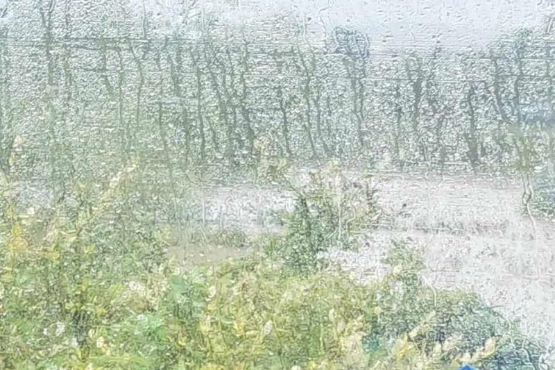 The view any passenger lucky to have their train journey going ahead today saw - rain-lashed windows and fields like lakes