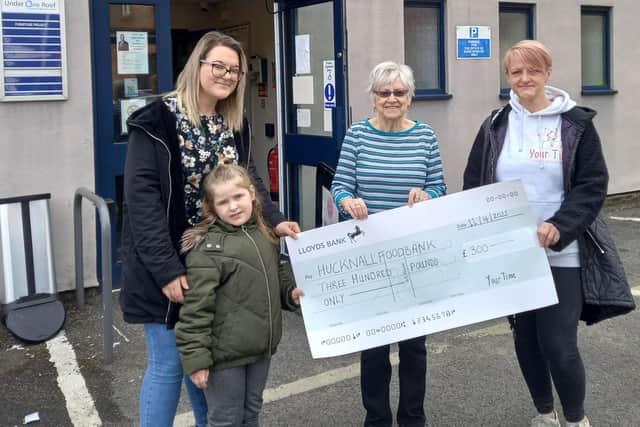 Theresa (right) and Lisa Gandy present the cheque for £300 to Yvonne Campbell at Hucknall Food Bank