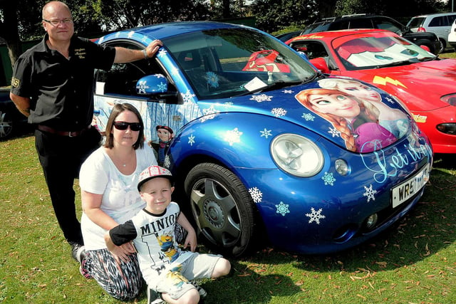 Dylan Henderson (8) his mum Susan an Mark Buckland, of North McQueen Hire, with a Frozen-themed motor at a park Fun Day in 2015