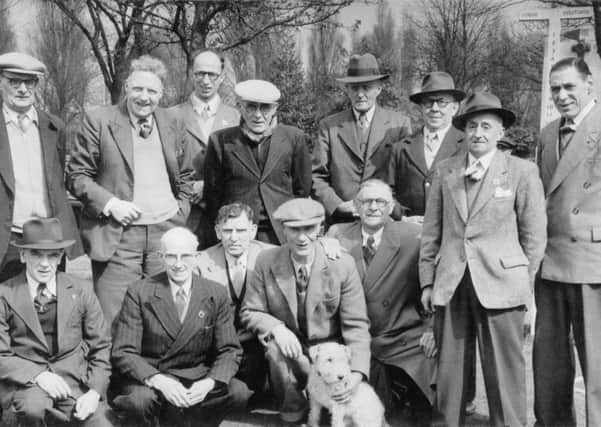 1960: A wonderful group shot of the mens bowls team, taken at Tichfield Park, Hucknall. Sam Bakewell is pictured above standing , third from the left and Bob Beswick is sitting in the centre with the dog. Picture courtesy of Nottinghamshire Archives.
