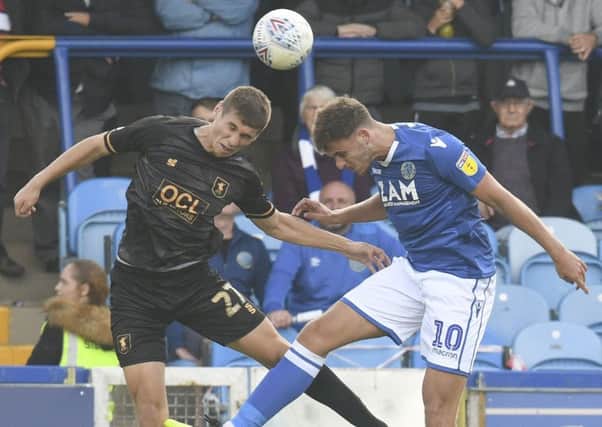 Macclesfield Town's Harry Smith and Mansfield Town's Lewis Gibbons compete for a header: Picture by Steve Flynn/AHPIX.com, Football: Sky Bet League Two match Macclesfield Town -V- Mansfield Town at Moss Rose, Macclesfield, Cheshire, England copyright picture Howard Roe 07973 739229