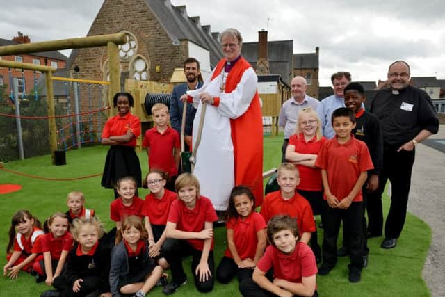 Blessing of new playground at Bulwell St MaryÃ¢Â¬"s Primary School, the Rt Revd Anthony Porter tries out the new equipment