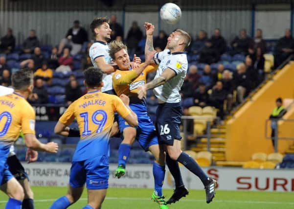 Mansfield Town v Oldham.
Danny Rose is sandwiched between defenders in the penalty box.
