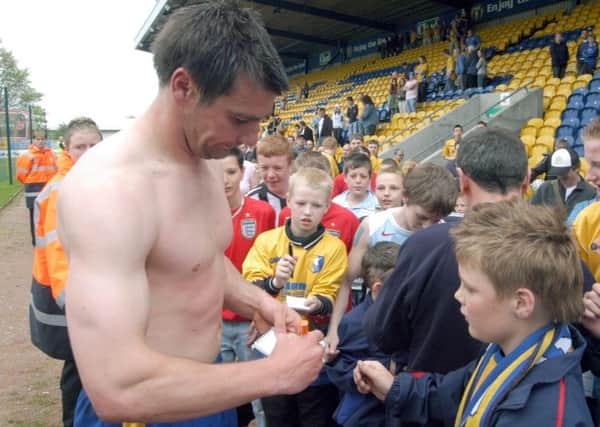 06-0977-11

Stags captain Richie Barker signs autographs for young fans on Saturday