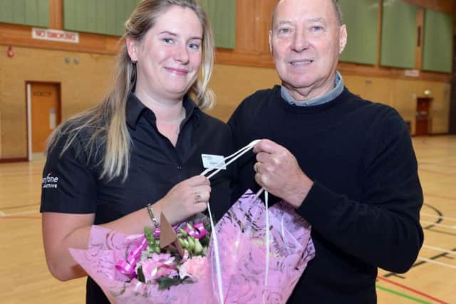 Merv Williams presents flowers to Hucknall Leisure Centre operations manager Emma Smithurst, who helped to save his life.