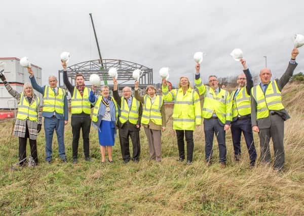 Councillors and council officers join representatives of Flying High Academy to celebrate the start of work on the new school.