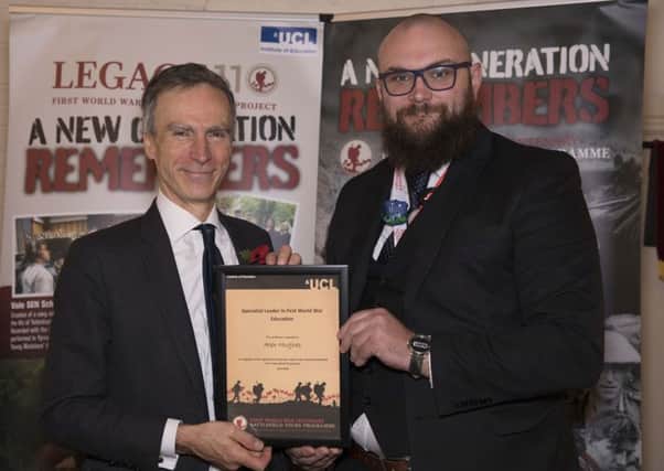 Teacher Alex Hughes (right) receives his specialist award.