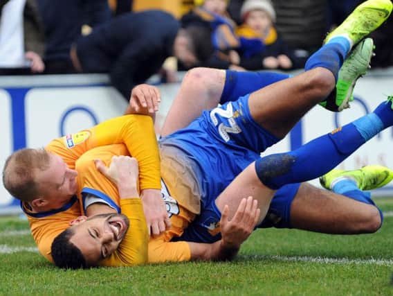 CJ Hamilton is embraced by Neal Bishop after scoring the second Stags goal. Photo: Anne Shelley.