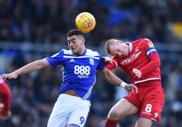 Che Adams of Birmingham City and Ben Watson of Nottingham Forest in action.