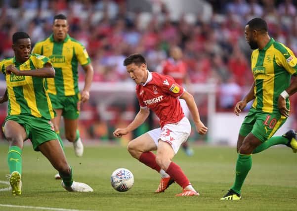 Joe Lolley draws the attention of three West Bromwich Albion defenders