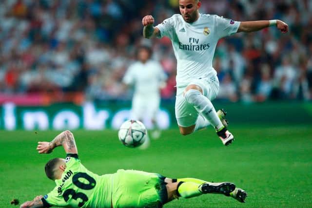 MADRID, SPAIN - MAY 04:  Nicolas Otamendi of Manchester City makes a tackle on Jese of Real Madrid  during the UEFA Champions League semi final, second leg match between Real Madrid and Manchester City FC at Estadio Santiago Bernabeu on May 4, 2016 in Madrid, Spain.  (Photo by Gonzalo Arroyo Moreno/Getty Images)