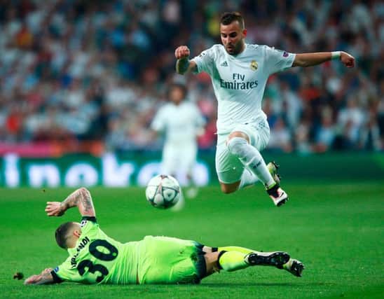 MADRID, SPAIN - MAY 04:  Nicolas Otamendi of Manchester City makes a tackle on Jese of Real Madrid  during the UEFA Champions League semi final, second leg match between Real Madrid and Manchester City FC at Estadio Santiago Bernabeu on May 4, 2016 in Madrid, Spain.  (Photo by Gonzalo Arroyo Moreno/Getty Images)