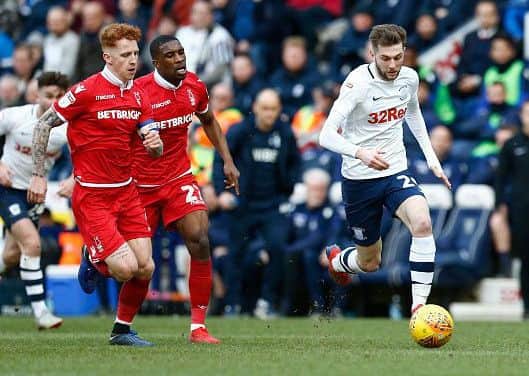 16th February 2019, Deepdale, Preston, England; EFL Championship football, Preston North End versus Nottingham Forest; Tom Barkhuizen of Preston North End breaks past Jack Colback and Tendayi Darikwa of Nottingham Forest (photo by Alan Martin/Action Plus via Getty Images)