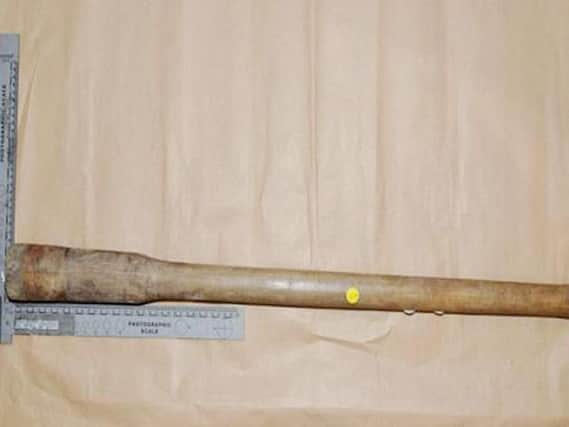 Pick axe handle pictured, which was used in another crime.