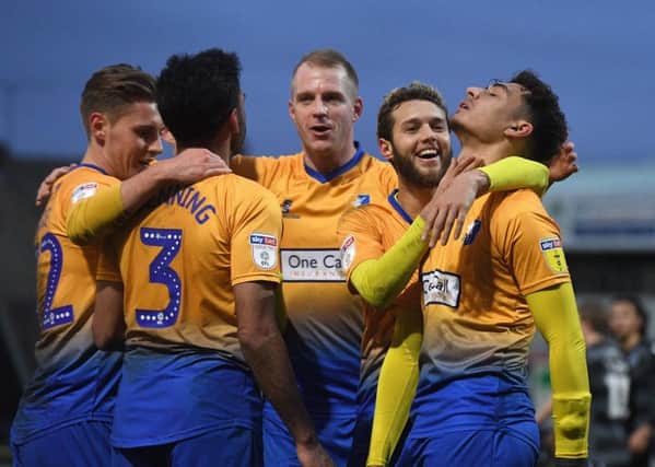 Mansfield's players celebrate a goal.