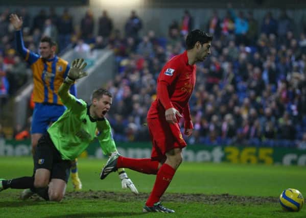 MANSFIELD, ENGLAND - JANUARY 06:  Luis Suarez of Liverpool goes around Alan Marriott of Mansfield Town to score during the FA Cup with Budweiser Third Round match between Mansfield Town and Liverpool at One Call Stadium on January 6, 2013 in Mansfield, England.  (Photo by Clive Mason/Getty Images)