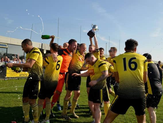 Hucknall Town's players celebrate their title win.
